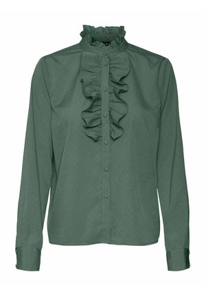 Blouse verte à manches longues avec boutonnière sur le devant, col monté à volants et détail volanté vertical au centre.