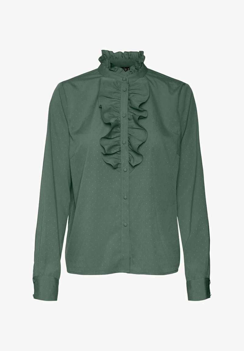 Blouse verte à manches longues avec boutonnière sur le devant, col monté à volants et détail volanté vertical au centre.