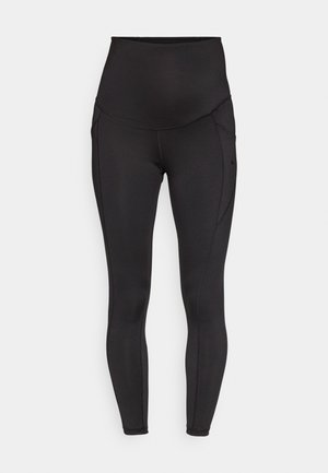 Black high-waisted leggings made of stretchy fabric, featuring side seams and a smooth, textured finish with no visible patterns or logos.