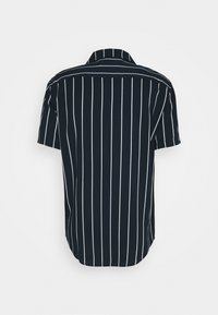 Short-sleeve shirt in navy blue with vertical white stripes. Features a classic collar and a rounded hem for a relaxed fit.