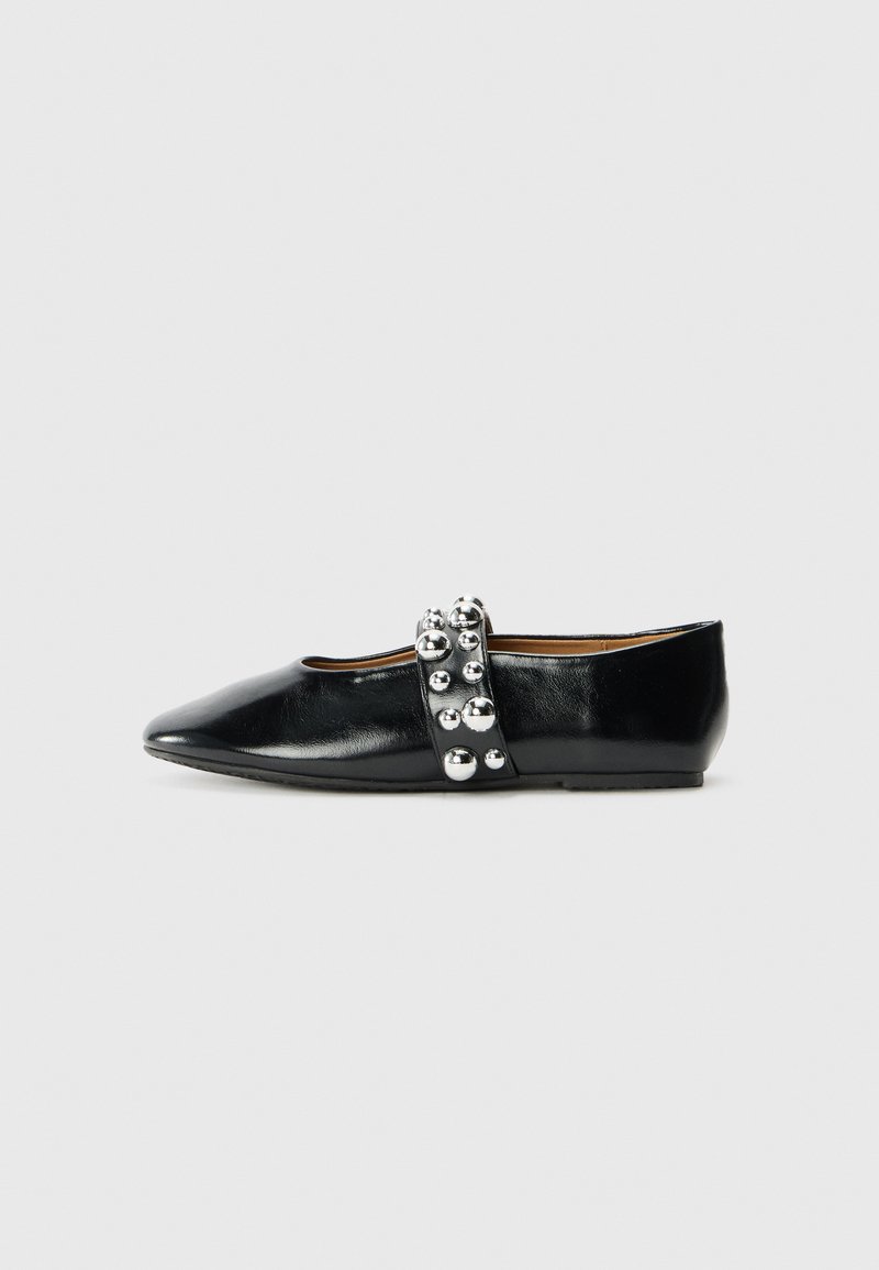 Black leather ballet flat with pointed toe, featuring a decorative strap adorned with metallic spheres. Smooth texture, low heel.