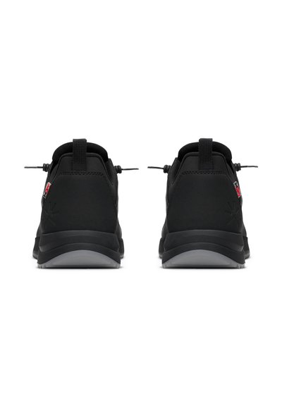 Black athletic shoes featuring a textured upper, enclosed lacing system, and a contrasting gray sole. Reinforced heel with pull tab.