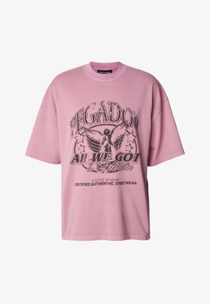 Rozā oversize stila T-krekls no kokvilnas, ar melnu grafisku apdruku, kurā ir teksts un ērglis. Klasisks apaļš kakla izgriezums un īsas piedurknes.