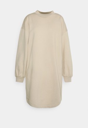 Beige mekko, joka on valmistettu pehmeästä kankaasta. Siinä on korkea kaula, pitkät puffihihat ja löysä istuvuus, halkio on polven ylle.