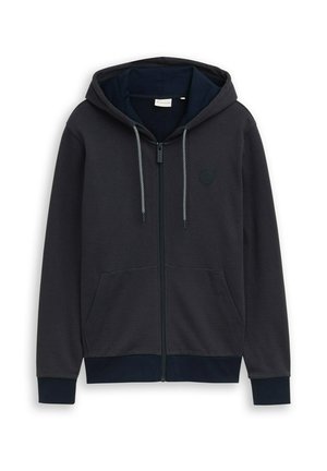 Schwarzer Hoodie mit durchgehendem Reißverschluss, Kordelzug, Fronttaschen, gerippten Bündchen und einem dezenten runden Logo auf der linken Brust.
