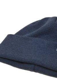 Navy blue knitted beanie made from soft fabric, featuring a ribbed texture and folded cuff with a small tag detail.