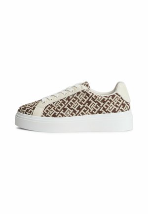 Brown and white low-top sneaker with white laces, patterned fabric upper, white leather trim, and thick white rubber sole.