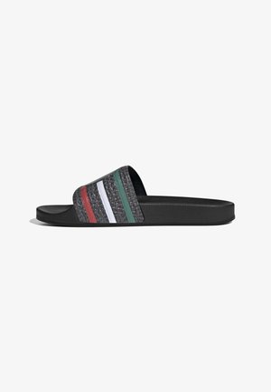 Black slide sandal with textured strap featuring vertical red, white, and green stripes, and cushioned sole.