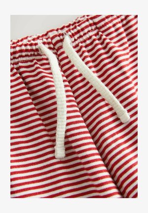 Shorts à rayures rouges et blanches avec une texture douce, comprenant un cordon blanc et une taille élastique.