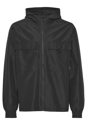 Black lightweight jacket made of ripstop material, featuring a zip front, adjustable hood, and two chest pockets with flaps. Elastic cuffs.