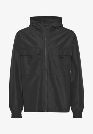 Black lightweight jacket made of ripstop material, featuring a zip front, adjustable hood, and two chest pockets with flaps. Elastic cuffs.