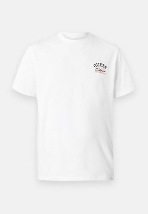 T-shirt blanc à manches courtes avec petit logo texte "GUESS 1981 California Los Angeles" sur la poitrine gauche.