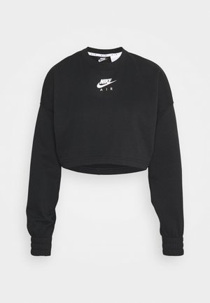Czarna krótka bluza z długimi rękawami, elastycznymi mankietami i białym logo Nike Air na środku klatki piersiowej.