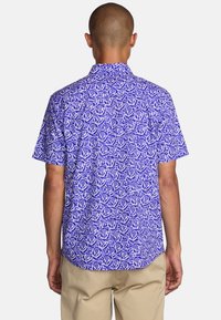 Short-sleeve shirt featuring a floral pattern in white on a purple background, made of lightweight fabric with a classic collar design.