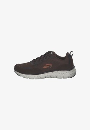 Brown mesh athletic shoe with textured overlay, speckled white midsole, and black rubber outsole. Features logo in orange on the side.