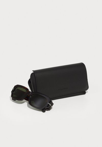 Tortoiseshell sunglasses with dark lenses and silver hardware, alongside a black leather case featuring embossed branding.