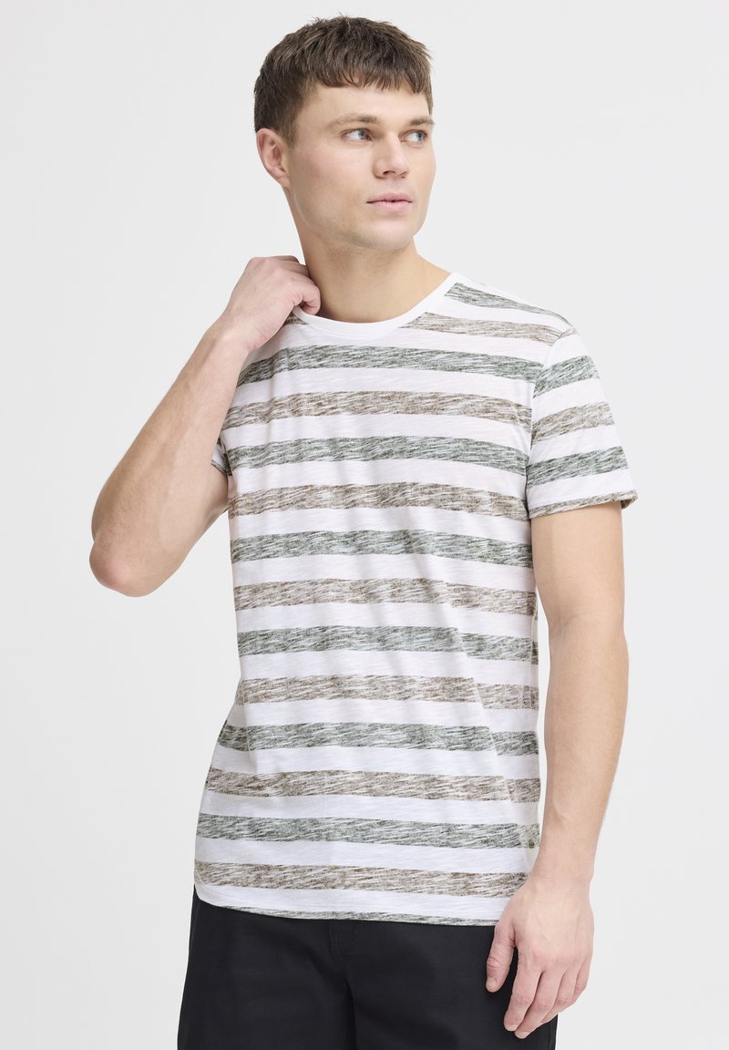 Striped t-shirt in white, green, and brown. Short sleeves, round neck, soft texture. Horizontal wavy stripes create a casual design.