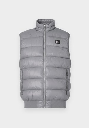Gray puffer vest with a high collar, front zip closure, and two side zip pockets. Made from a smooth, shiny material; ribbed hem.