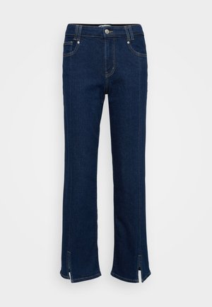 Sötétkék farmernadrág, egyenes lábbal, finom varrási részletekkel és oldalsó hasítékokkal az alján, egyedi befejezéssel.