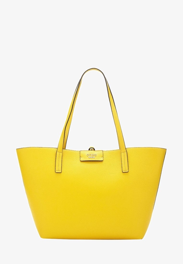 Sac fourre-tout en cuir jaune avec deux poignées et une petite plaque avec logo doré au centre à l'avant.