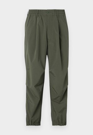 Green cargo pants with an elastic waistband, button closure, side pockets, and elastic cuffs at the ankles. Made from lightweight material.
