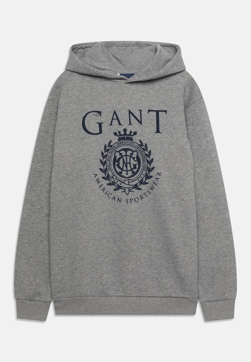 Felpa grigia in morbido tessuto con un grande logo GANT blu navy e una grafica a forma di corona sul davanti. Include una tasca a marsupio.