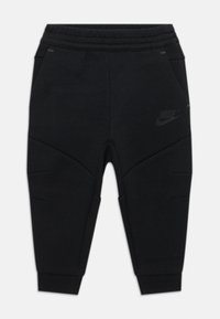 Pantaloni da jogging neri Nike con vita a costine, gambe affusolate, tasche laterali e pannelli testurizzati per un tocco di design in più.