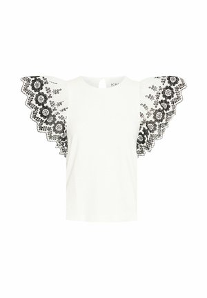Biela tričko s čiernymi vyšívanými čipkovými rukávmi s kvetinovými motívmi a zvlnenými okrajmi; okrúhly výstrih a otvor v zadnej časti.