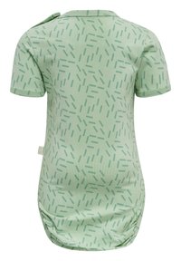 Bodysuit à manches courtes, de couleur vert menthe, avec un motif de lignes dispersées, en coton doux, et une fermeture à pression réglable sur les épaules.