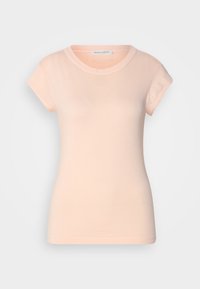 T-shirt ajusté à manches courtes en coton pêche clair. Présente un col rond classique et une texture lisse avec des coutures discrètes.