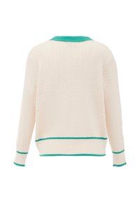 Virknad kreamfärgad kofta med grön krage och manschetter, ribbat mönster och kontrasterande gröna detaljer vid fåll och ärmar.