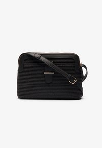Black crossbody bag with a textured woven design, leather accents, zip closure, and adjustable strap featuring a gold-tone hardware detail.