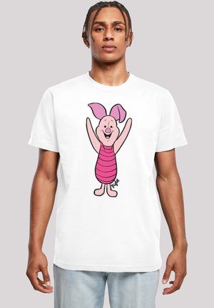 White t-shirt featuring a cartoon pig character with pink skin, large ears, and striped pink clothing, smiling with arms raised.