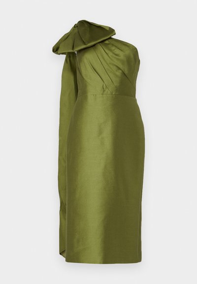Green satin dress with a structured bodice, asymmetric one-shoulder design, and oversized bow detail at the shoulder. Smooth texture.