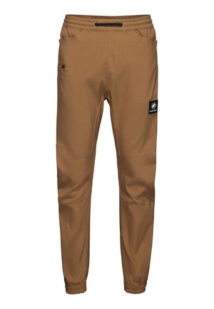 Braune, zulaufende Outdoor-Hose mit elastischem Bund und Bündchen, seitlicher Reißverschlusstasche und schwarzem Mammut-Logo am Oberschenkel.