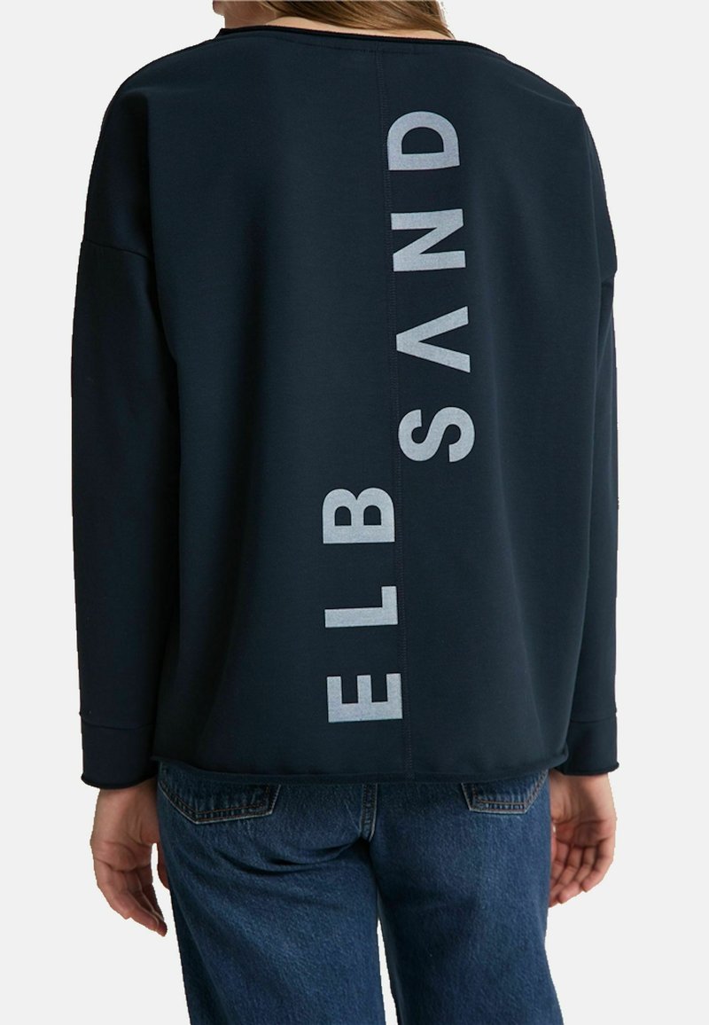 Dark navy sweatshirt featuring a wide neckline and long sleeves, with the text "ELB SAND" in large light gray letters down the back.