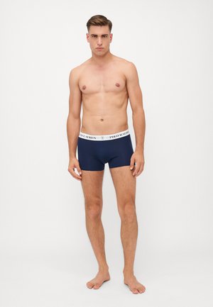 Boxers-culottes en coton bleu marine avec une ceinture blanche portant le logo "POLO RALPH LAUREN". Texture lisse, design ajusté, style minimaliste.