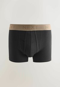 Černé bavlněné boxerské trenýrky s béžovým elastickým pasem zdobeným vyraženým logem "NEXT", hladkou texturou a přiléhavým střihem.