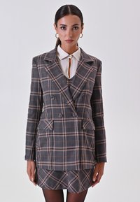 Grau gestreifter Doppelreiher-Blazer mit pink-weißer Karomuster, breiten Revers, Taschenklappen und einem taillierten Minirock.