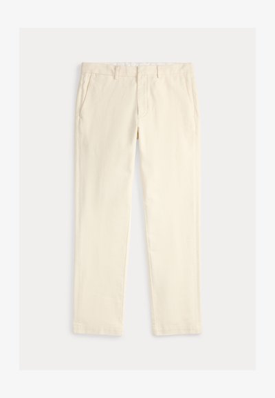 Béžové bavlnené nohavice so rovnými nohavicami, ktoré majú dve predné vrecká a plochý predný diel, hladká textúra bez vzorov.