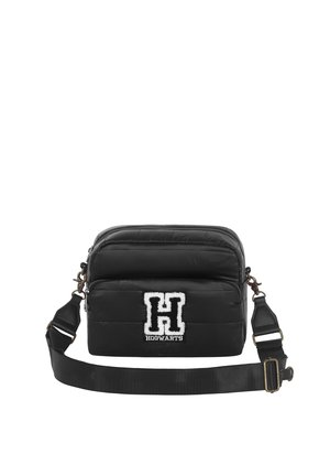 Black padded crossbody bag with adjustable strap, featuring a white Hogwarts logo and soft texture. Zippered top and front pocket.