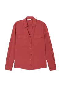 Chemise à manches longues boutonnée en rose poussiéreux, en tissu texturé, avec deux poches sur la poitrine et un ourlet arrondi. Détails subtils des boutons sur les manches.