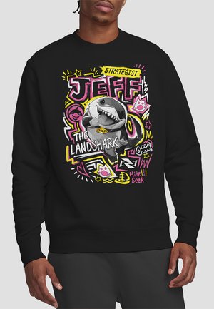 Schwarzer Kapuzenpullover mit einem bunten Grafikdesign eines Cartoon-Haifischs, der "JEFF THE LANDSHARK" beschriftet ist, umgeben von lebhaften Texten und Kritzeleien.