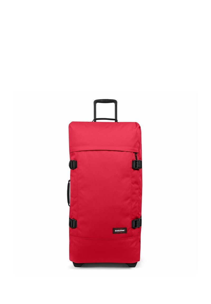 Red rolling suitcase made of sturdy fabric, featuring a retractable handle, two side clips, and a black logo on the front. Rectangular shape.