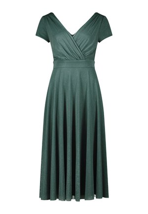 Robe verte à manches courtes et décolleté en V avec un design croisé. Jupe évasée, réalisée en tissu brillant avec de fines paillettes.