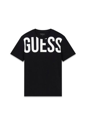 Camiseta negra de manga corta con gran texto blanco "GUESS" en el pecho superior y hombros.
