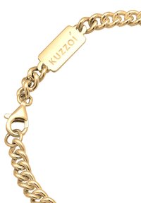 Gold chain bracelet with interconnected links, featuring a rectangular tag engraved with "Kuzzoi" and a robust lobster clasp for secure fastening.