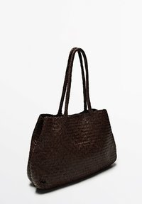 Woven brown tote bag with two long handles, featuring a textured surface and a structured shape, suitable for various daily uses.