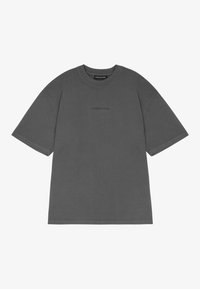 Uhlově šedé oversized tričko s krátkým rukávem, kulatým výstřihem a decentním tmavým logem umístěným na středu hrudi.
