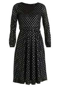 Schwarzes Kleid mit langen Ärmeln, V-Ausschnitt und silbernem Punkte-Muster. Weicher Stoff, taillierter Schnitt, fließender Rock und Detail mit Schlitz am Rücken.
